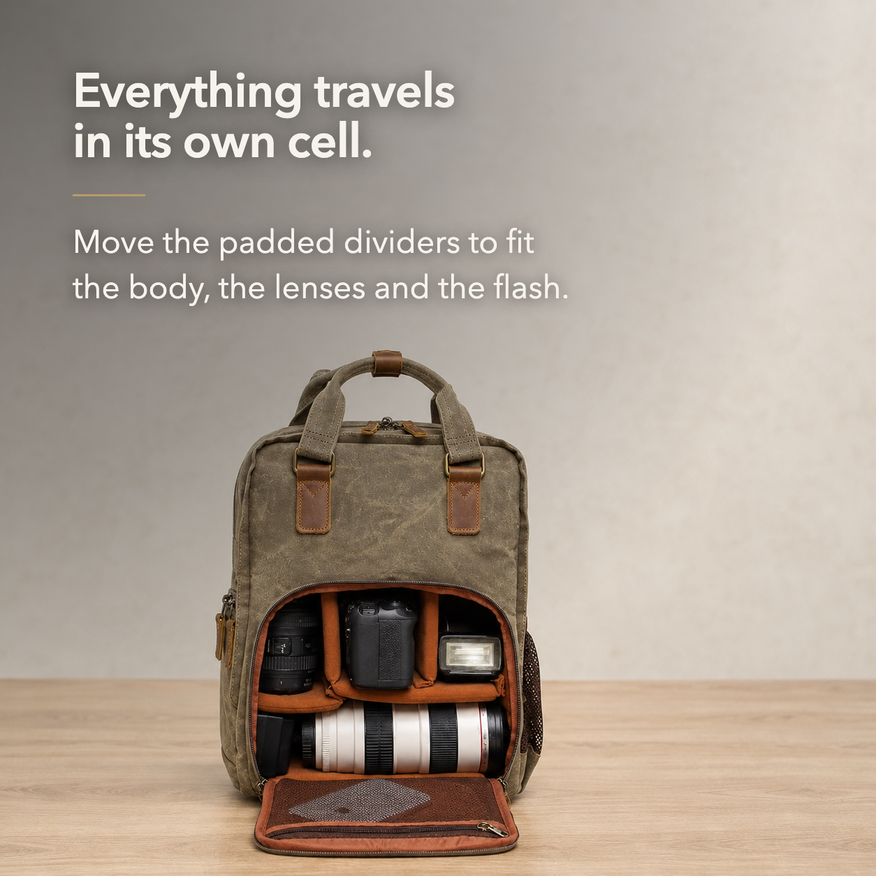 Camera backpack open on a table with a body, two lenses and a flash in padded cells.