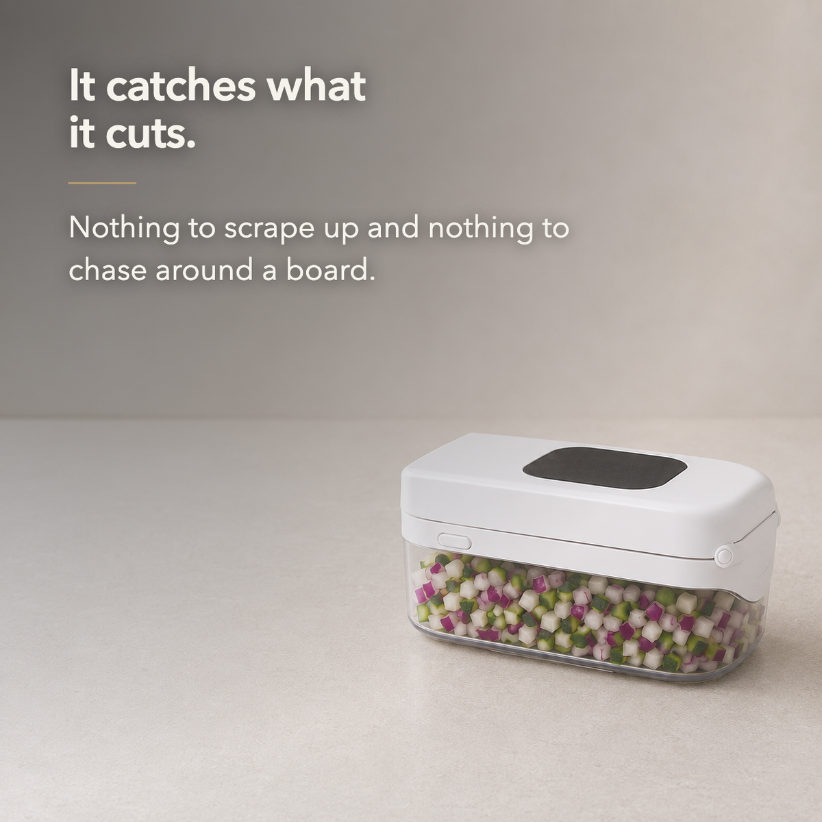 Text card reading It catches what it cuts, beside the closed white vegetable chopper with its clear container full of diced vegetables.