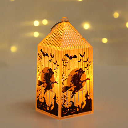 Mini Halloween lantern lit warm amber, printed with a witch on a broomstick flying across a full moon