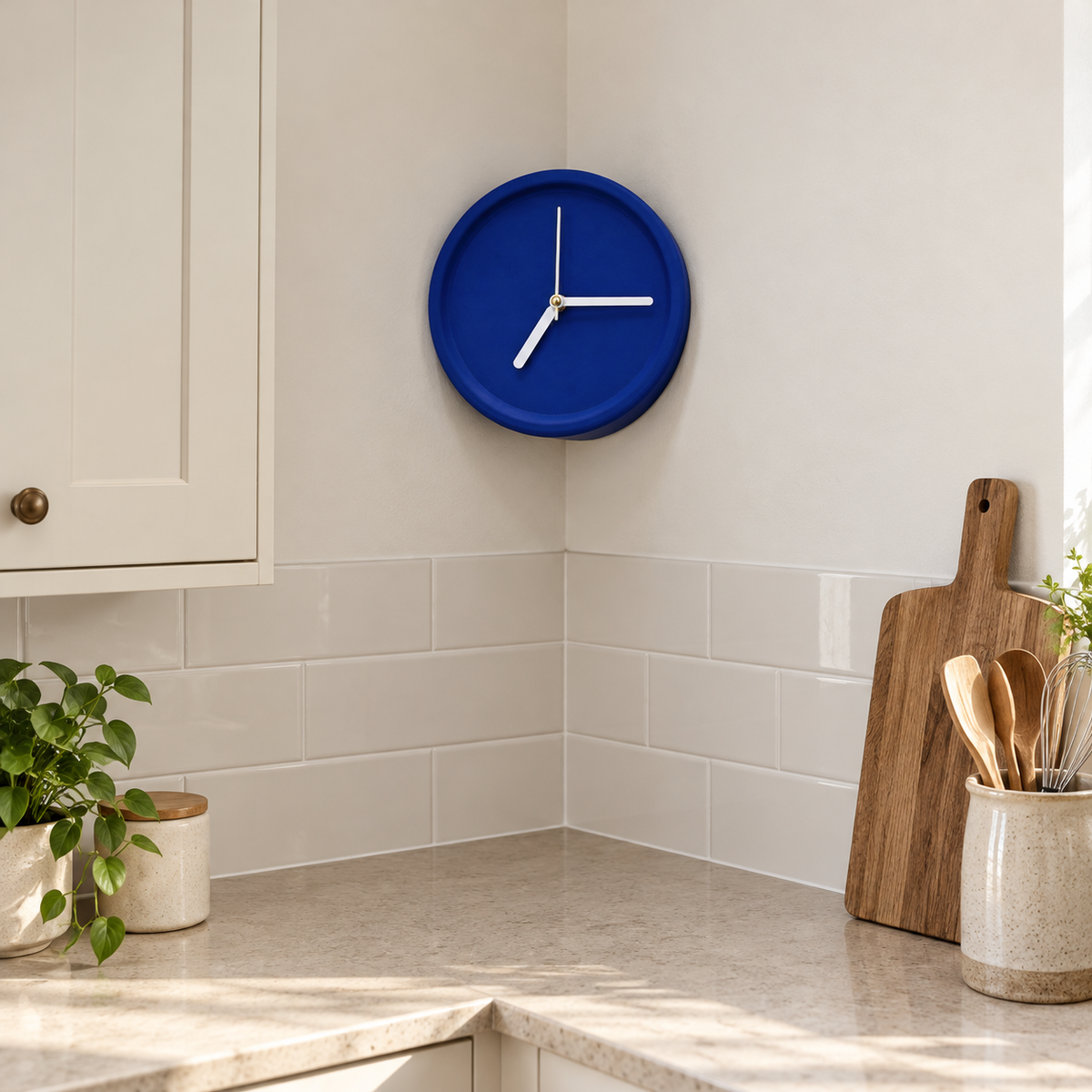 Blue corner wall clock in a kitchen corner above the counter