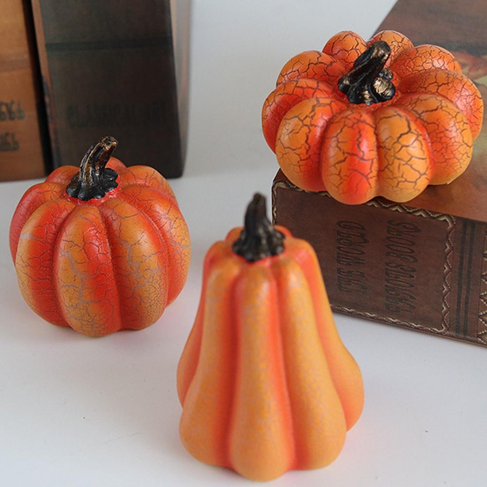 Three unlit resin pumpkin lights in daylight, showing the crackle finish