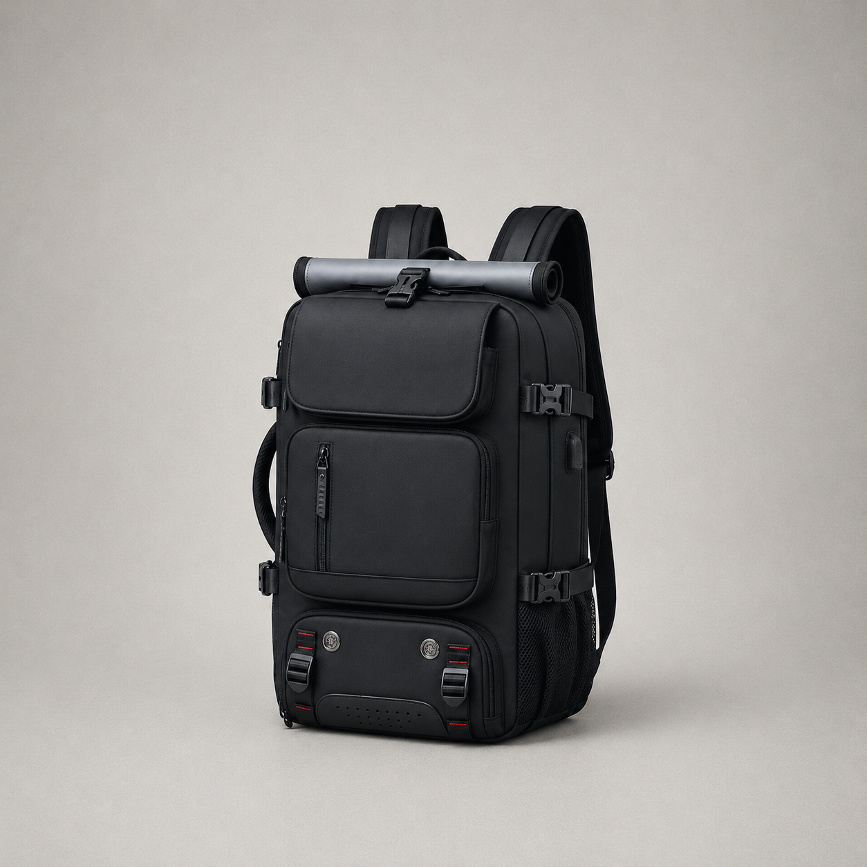 Black travel backpack on a plain gray background, front and right side visible, with the rolled gray sheet strapped across the top