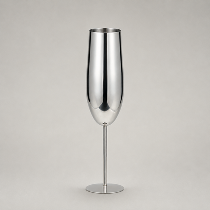 Single silver stainless steel champagne flute on a warm grey studio background