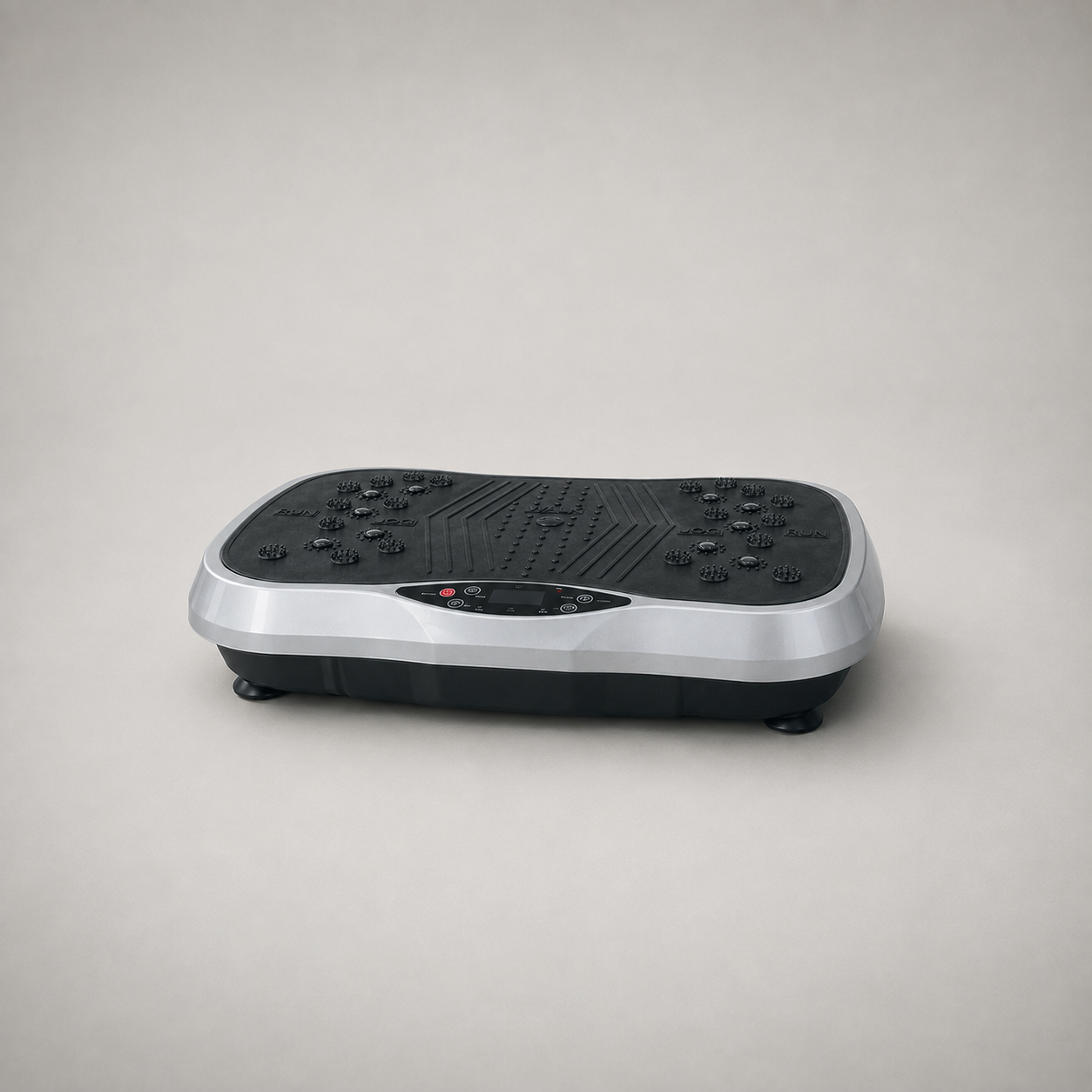 Silver and black vibration plate on a plain grey studio background, three quarter view