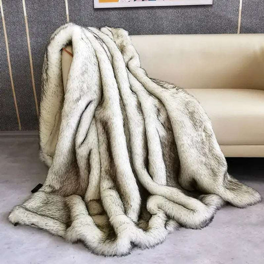 Silver faux fox fur throw draped over the arm of a cream sofa and pooling on the floor, white fur with charcoal-black tips in long ridges