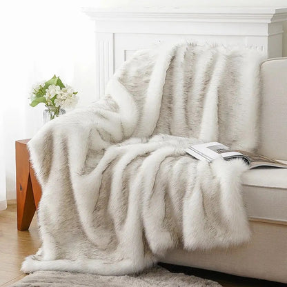 White faux fur throw draped over a cream sofa in a bright living room