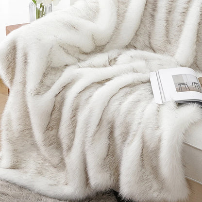 Close view of the white faux fur throw in deep folds, cream fur with faint warm tips