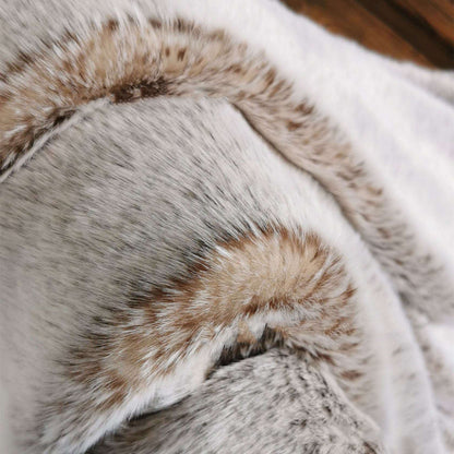 Close-up of the taupe throw, pale greige fur with brown-tipped stripes
