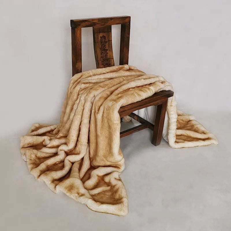 Caramel faux fur throw draped over a wooden chair, cream fur shading to golden caramel
