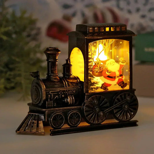 Vintage-style steam train Christmas lantern in an antique bronze finish, lit warm from inside, with Santa carrying his sack printed on the cab panel
