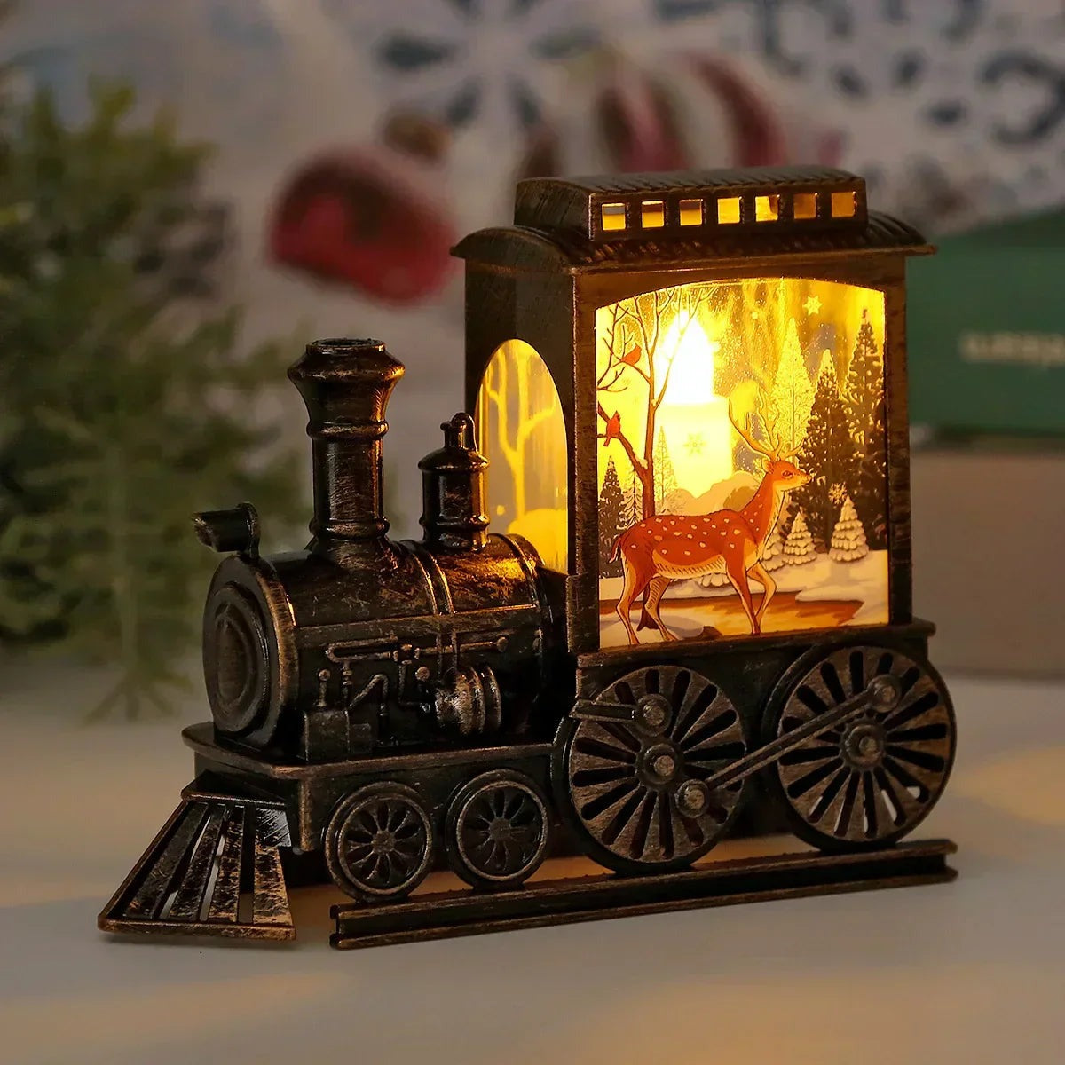 Lit vintage train lantern with a reindeer walking through a snowy forest on the cab panel and warm light in the roof vents