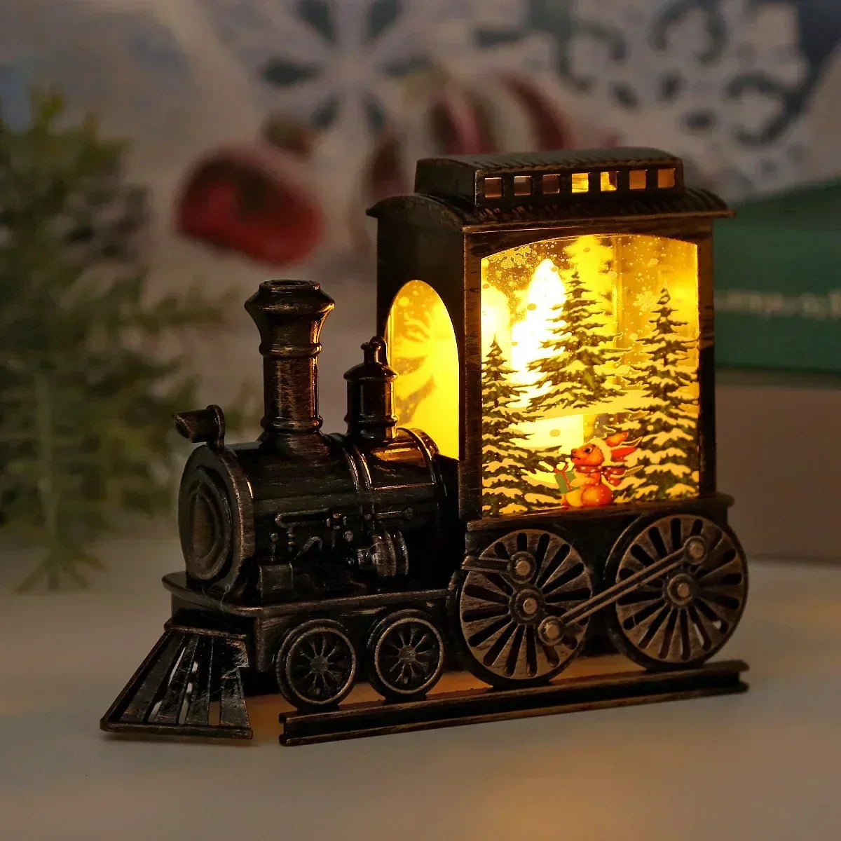 Vintage train Christmas lantern lit warm, its cab panel showing snow-covered pine trees and a small fox holding a gift