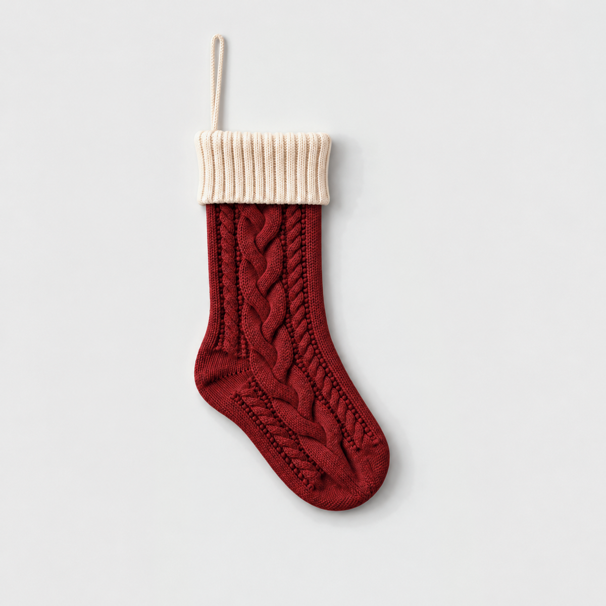 Red cable knit Christmas stocking with a cream ribbed cuff and cream hanging loop