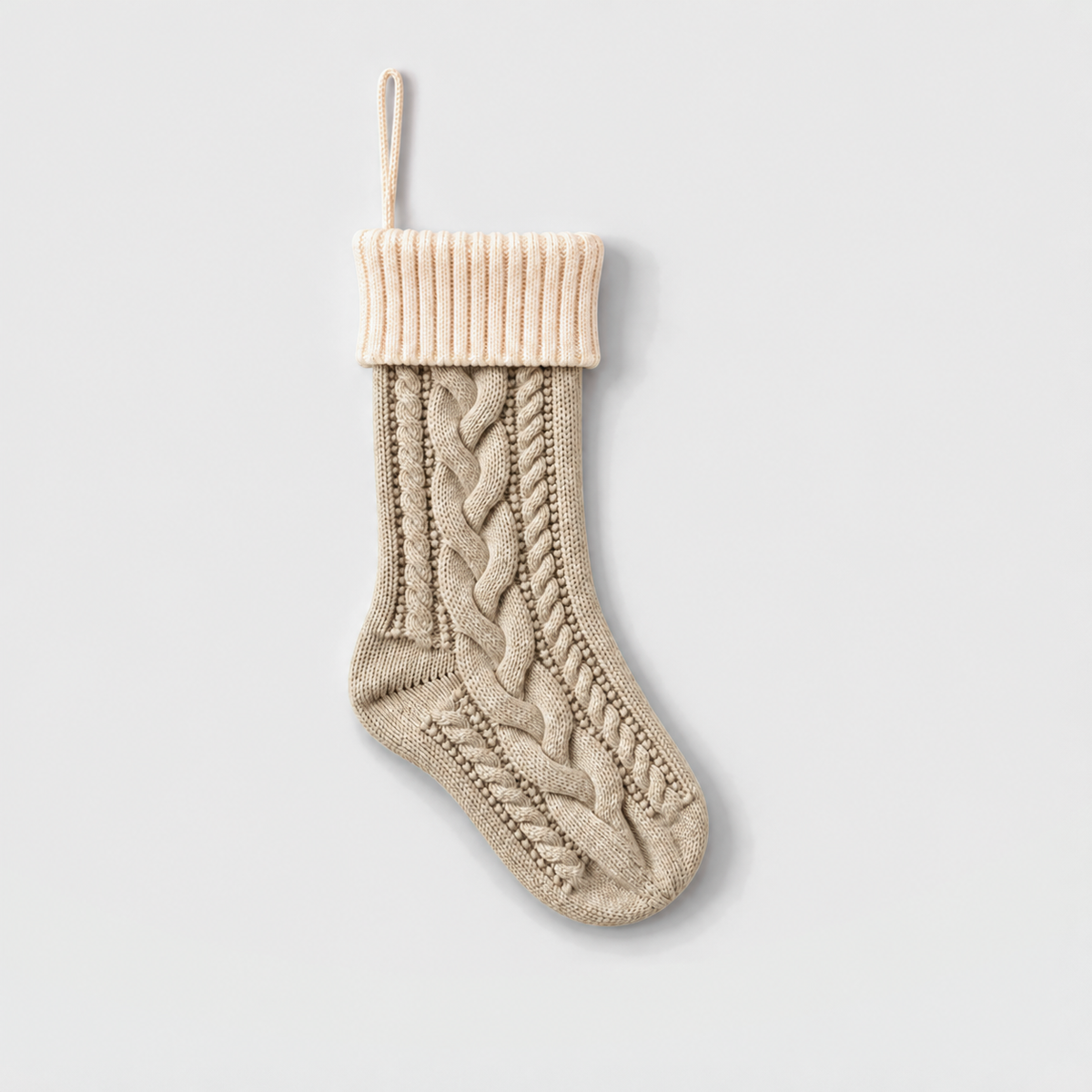 Beige cable knit Christmas stocking with a cream ribbed cuff and cream hanging loop