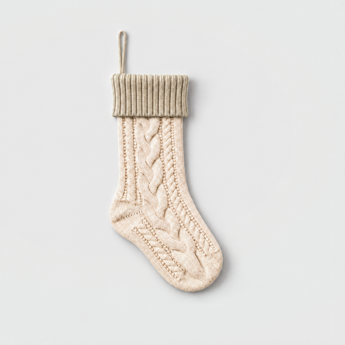 Cream cable knit Christmas stocking with a beige ribbed cuff and beige hanging loop