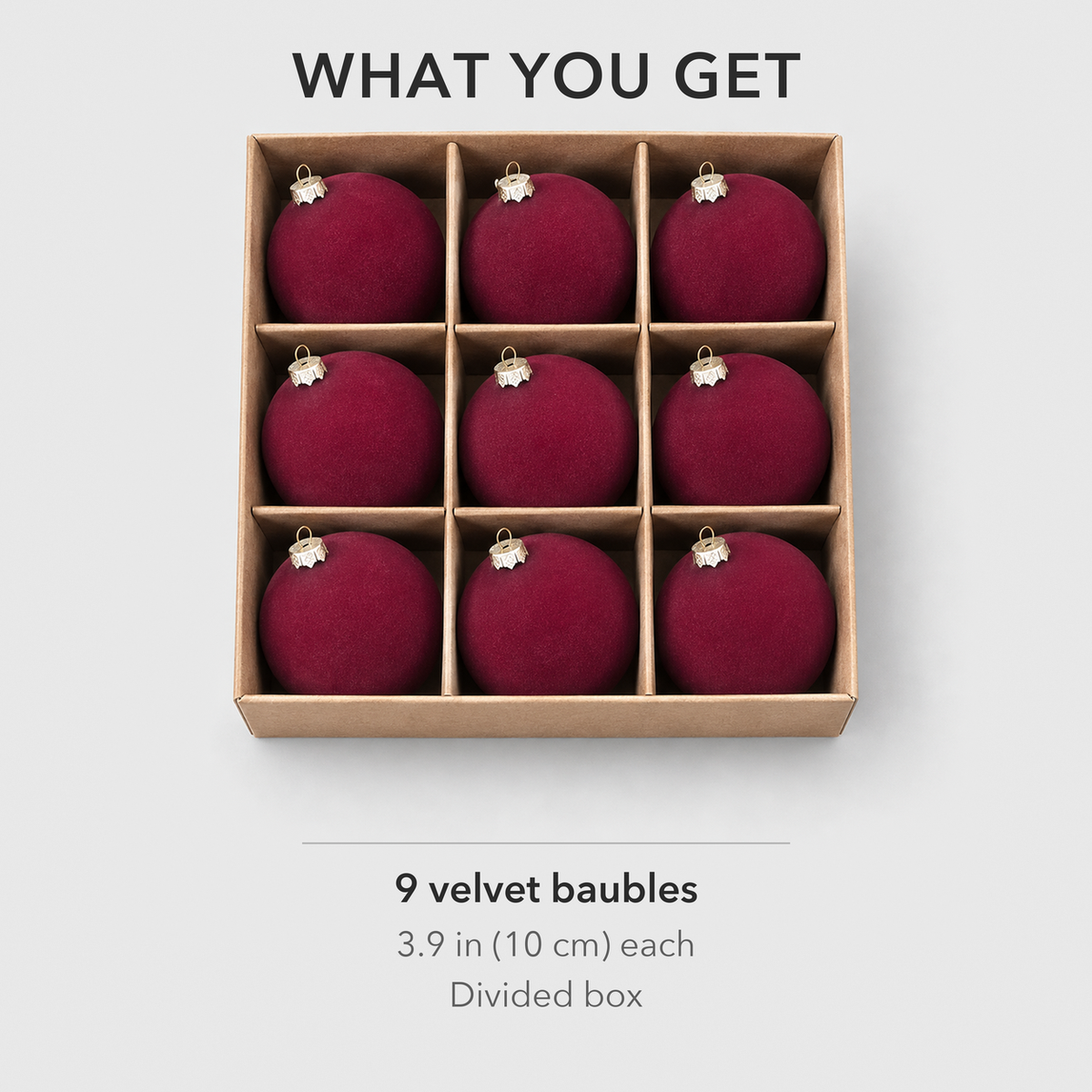 Nine burgundy velvet baubles in their divided box, one in each compartment