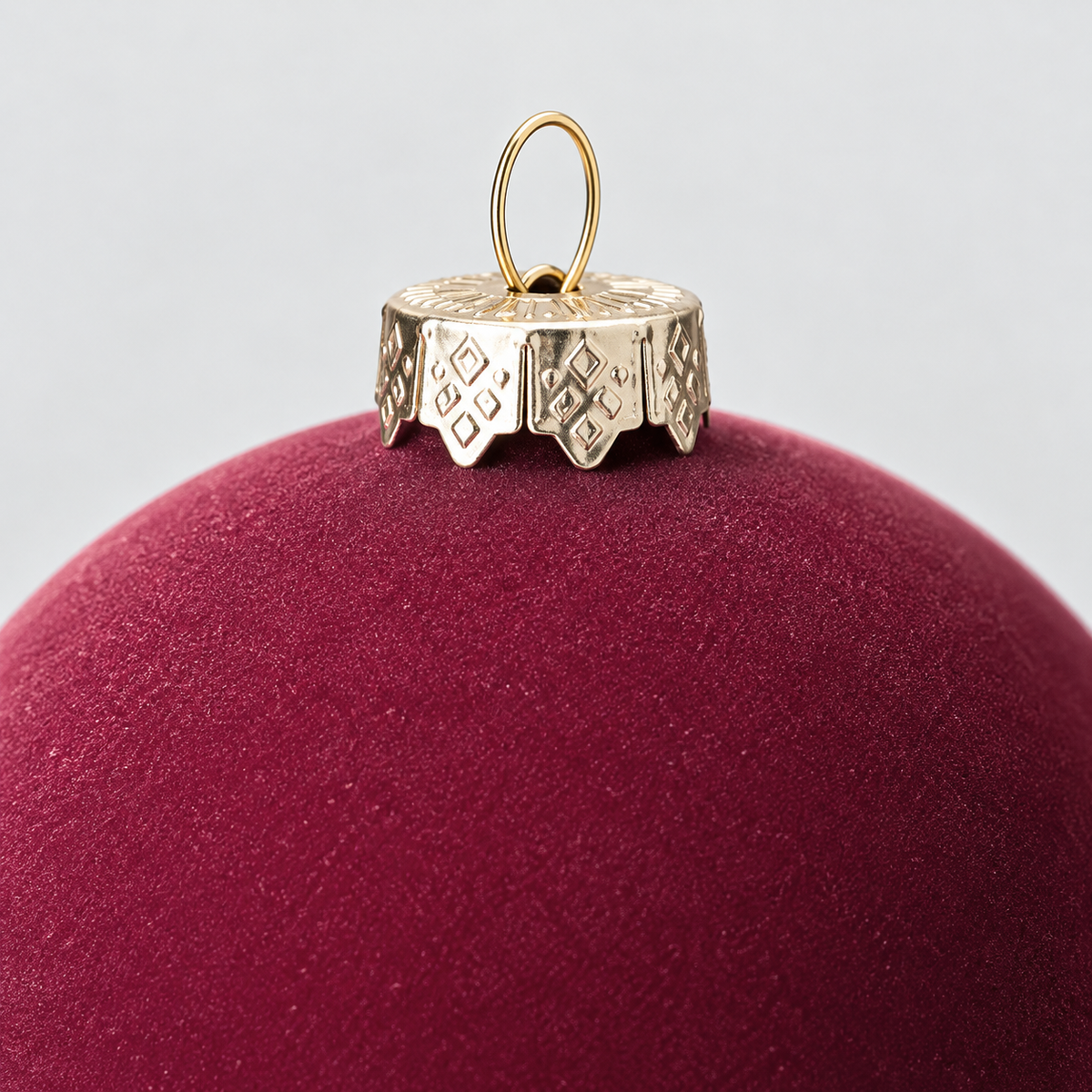 Close-up of the velvet surface and the silver-gold crown cap with its wire loop