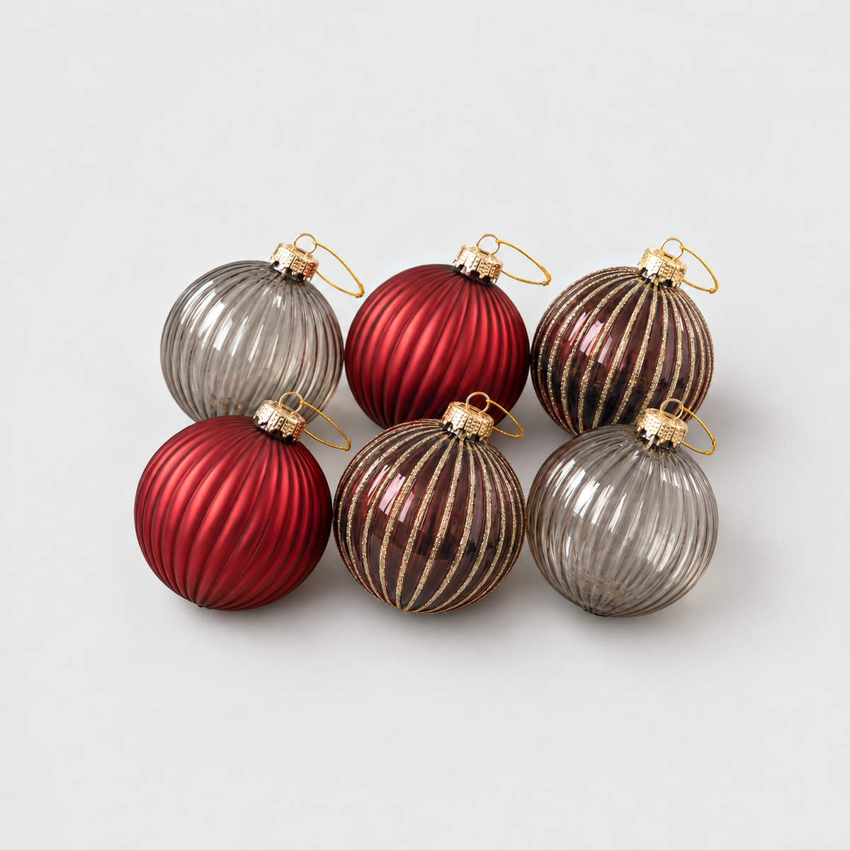 Six ribbed glass Christmas baubles in deep red matte, wine red with gold glitter stripes and smoky gray glass