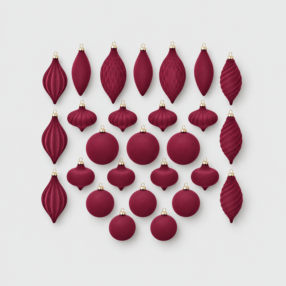 Twenty-seven burgundy velvet Christmas ornaments in eight shapes laid out on a light gray background