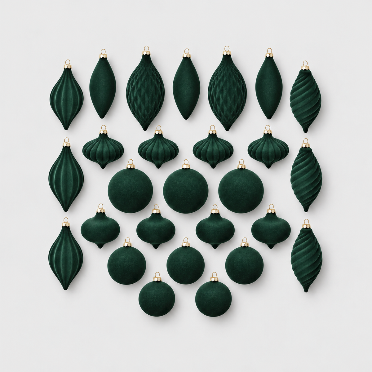 Twenty-seven green velvet Christmas ornaments in eight shapes laid out on a light gray background