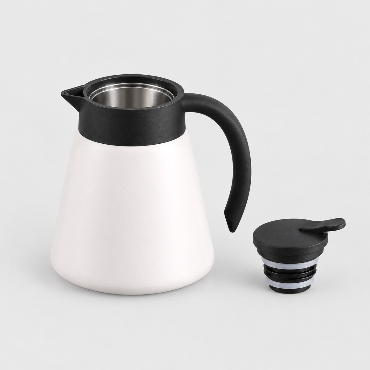 Thermal carafe with the screw-in lid removed, showing the stainless steel inside and the two seal rings on the stopper