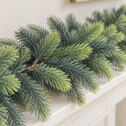 Close-up of the garland's pine tips showing light and dark green needles and the brown stem