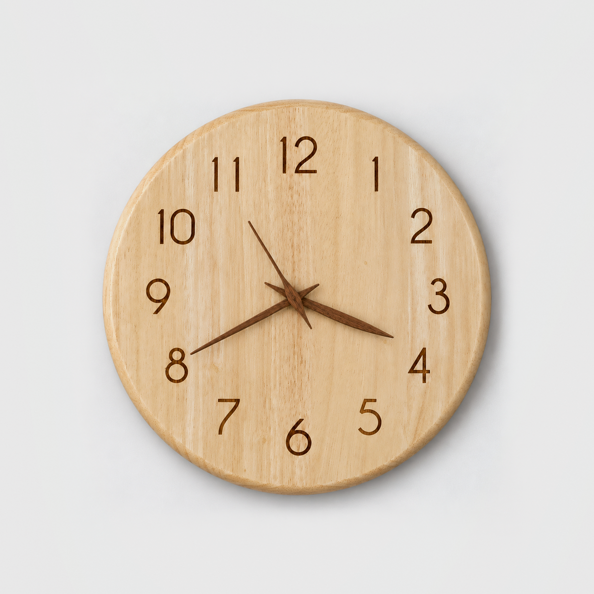Round pale rubberwood wall clock with engraved numbers and slim walnut-brown hour, minute and second hands, hanging on a light gray wall