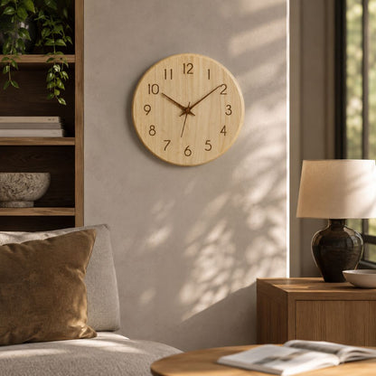 Wood wall clock on a sunlit plaster wall in a living room corner with a bookshelf, a sofa and a table lamp