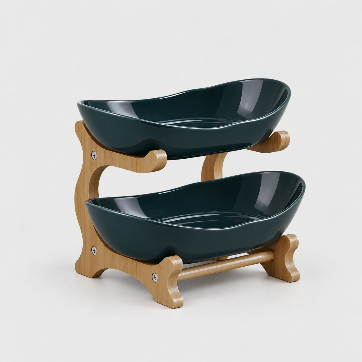 Two-tier fruit bowl stand with glossy deep green bowls on a bamboo frame, on a light gray background
