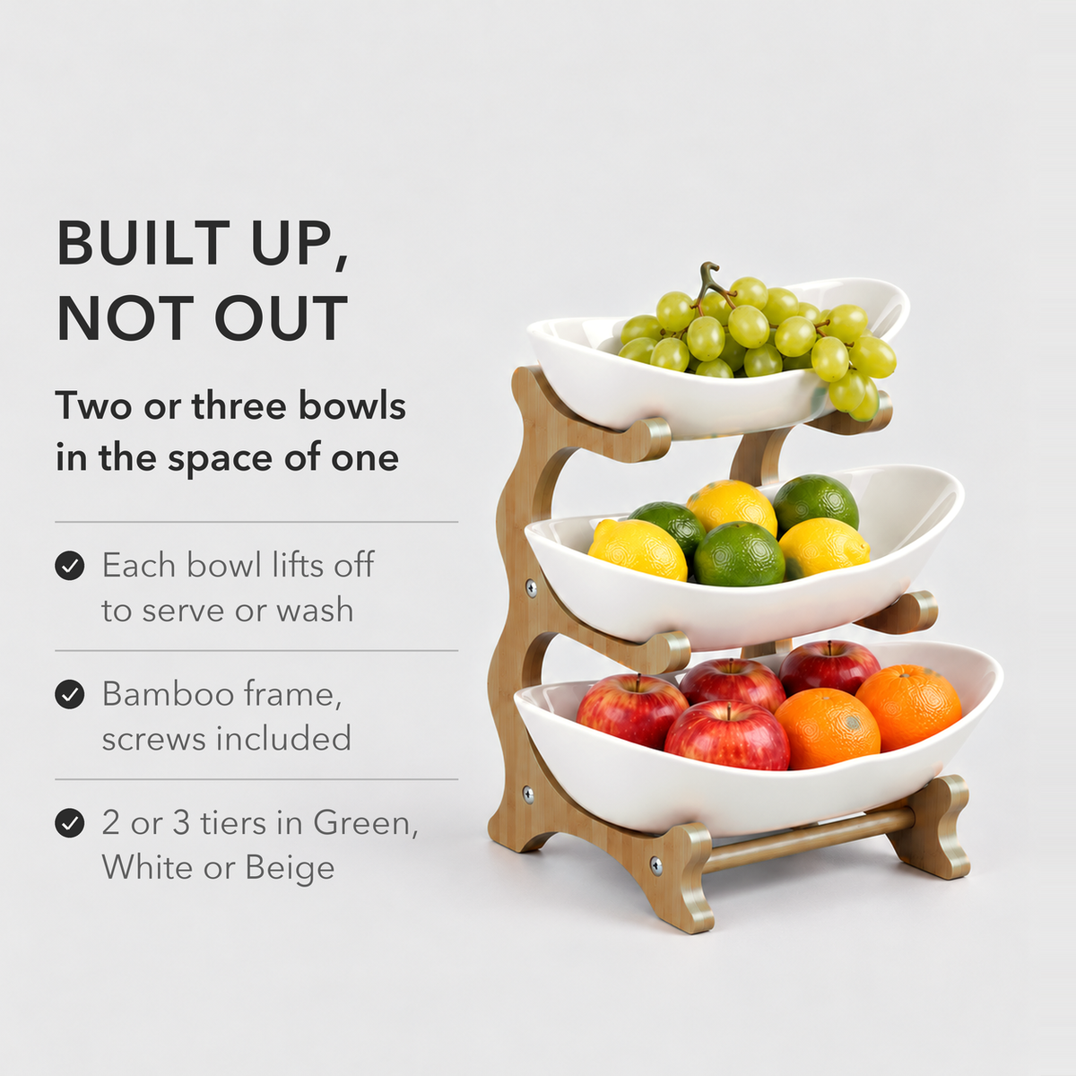 Three-tier fruit stand with white bowls of fruit: two or three bowls in the space of one, with bowls that lift off
