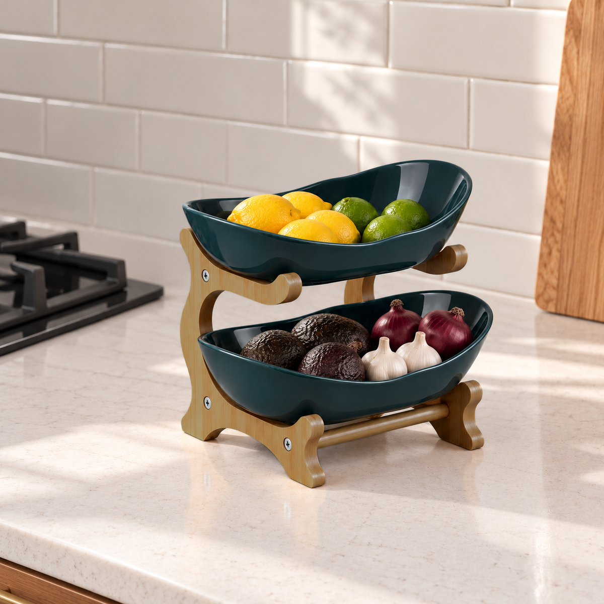 Green two-tier stand with lemons, limes, avocados and garlic on a counter beside the stove