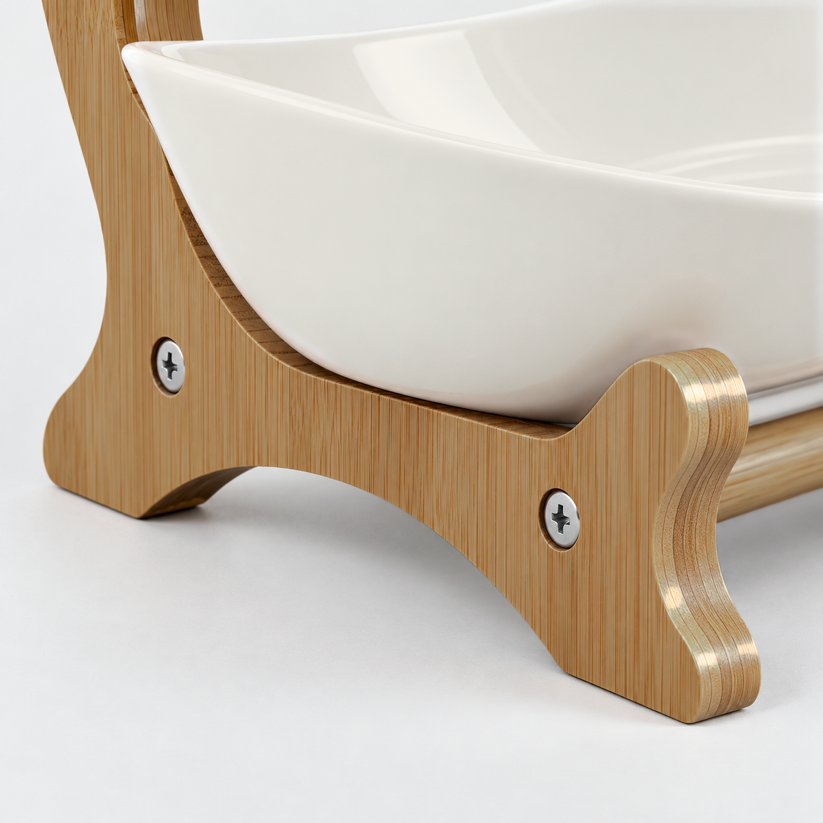 Close-up of the bamboo frame's foot, round base bar and small silver screw heads under a white bowl