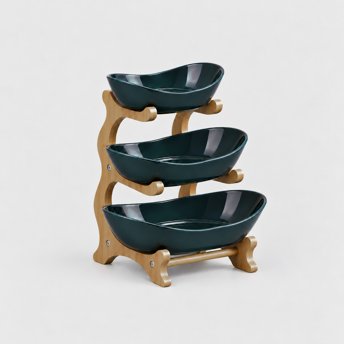 Three-tier fruit bowl stand with glossy deep green bowls on a bamboo frame