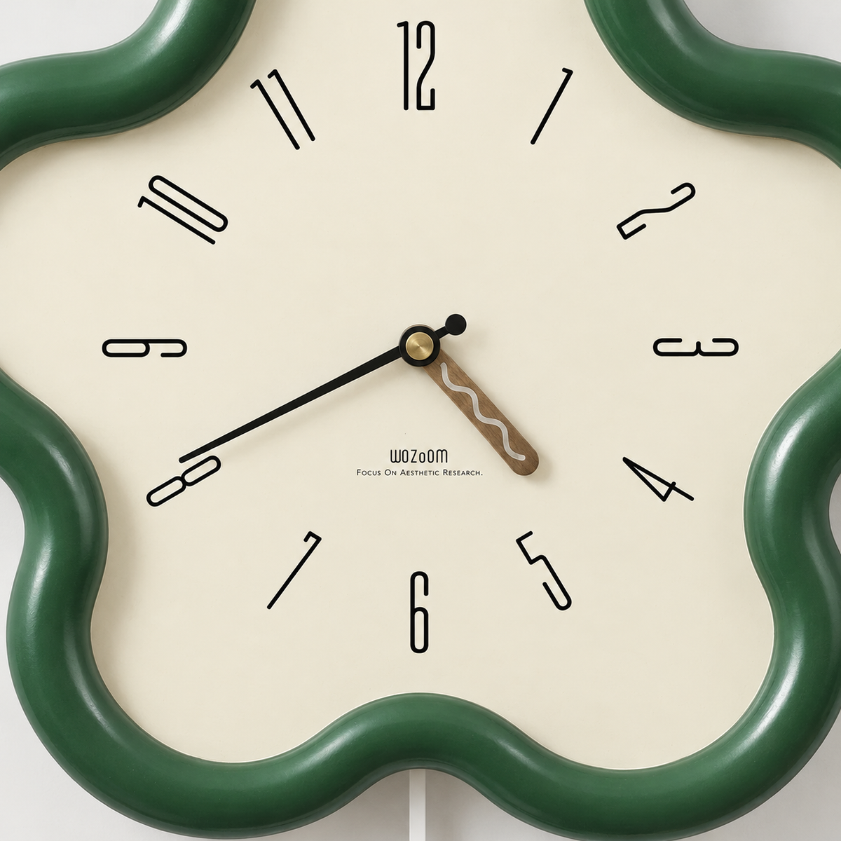 Close-up of the cream dial with slim turned numerals, a walnut hour hand with a wavy inlay and a black minute hand