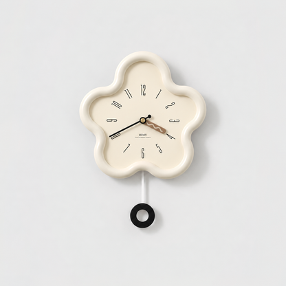 Cream flower shaped pendulum wall clock with a cream dial and a black ring pendulum on a light gray background