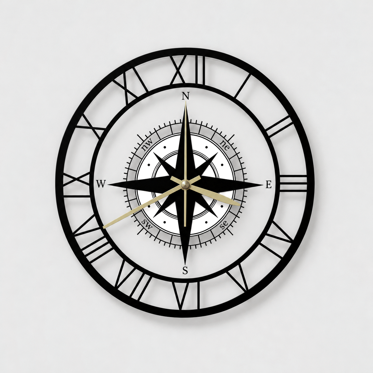 Round see-through compass wall clock with black Roman numerals, a black compass rose on a white center disc and gold hands, on a light gray wall