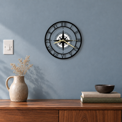 Clear compass wall clock with Roman numerals on a dusty blue living room wall above a walnut sideboard, the blue showing through the face