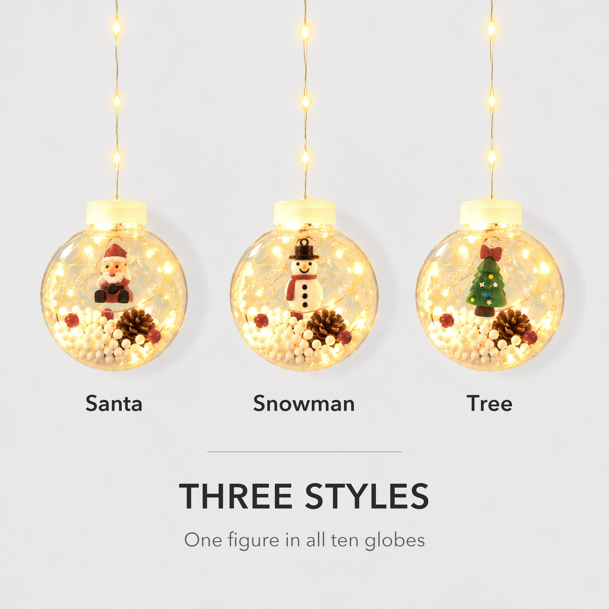 Three lit Christmas globes side by side showing the Santa, Snowman and Tree styles