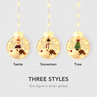 Three lit Christmas globes side by side showing the Santa, Snowman and Tree styles