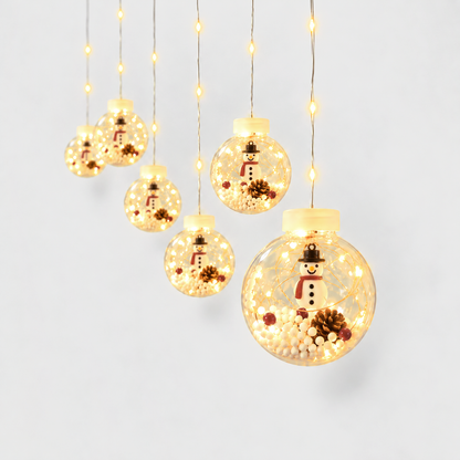 Christmas ball curtain lights with a snowman figure inside each clear globe, glowing warm white on a light gray background