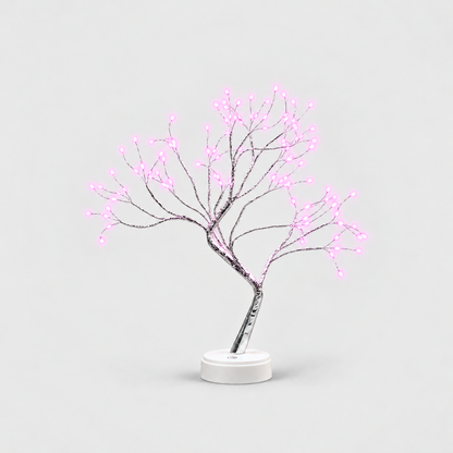LED tree lamp with silver branches and pink fairy lights, lit, on a white round base