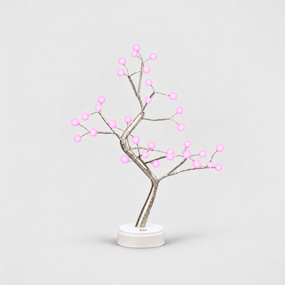 LED tree lamp with pale branches and 36 glowing pink pearl lights on a white round base