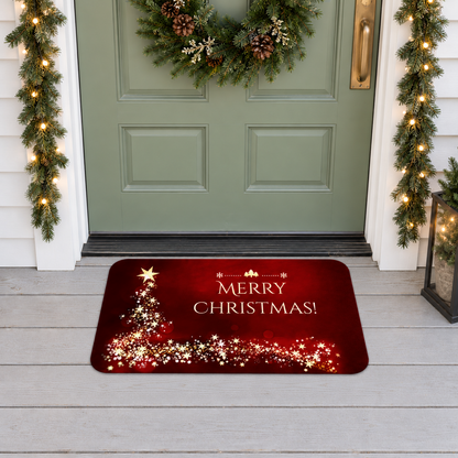 Merry Christmas door mat in red and gold on a covered front porch in front of a door with a Christmas wreath