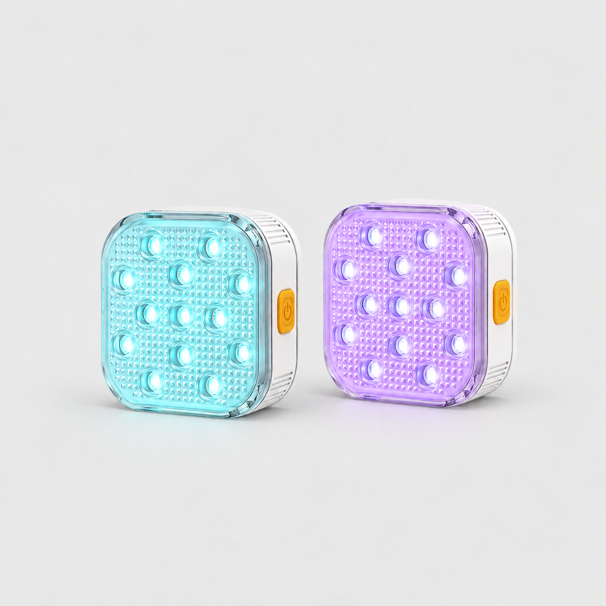 Two square rechargeable pool lights glowing aqua and violet, white body with an orange power button on the side