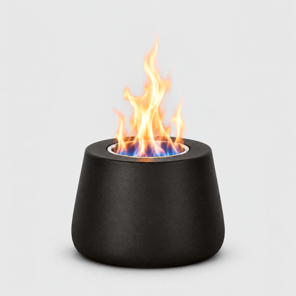 Black tabletop fire pit burning with a blue and orange flame from its stainless steel cup, on a light gray background