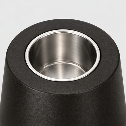 Close-up of the stainless steel burn cup seated in the flat matte black top of the fire pit