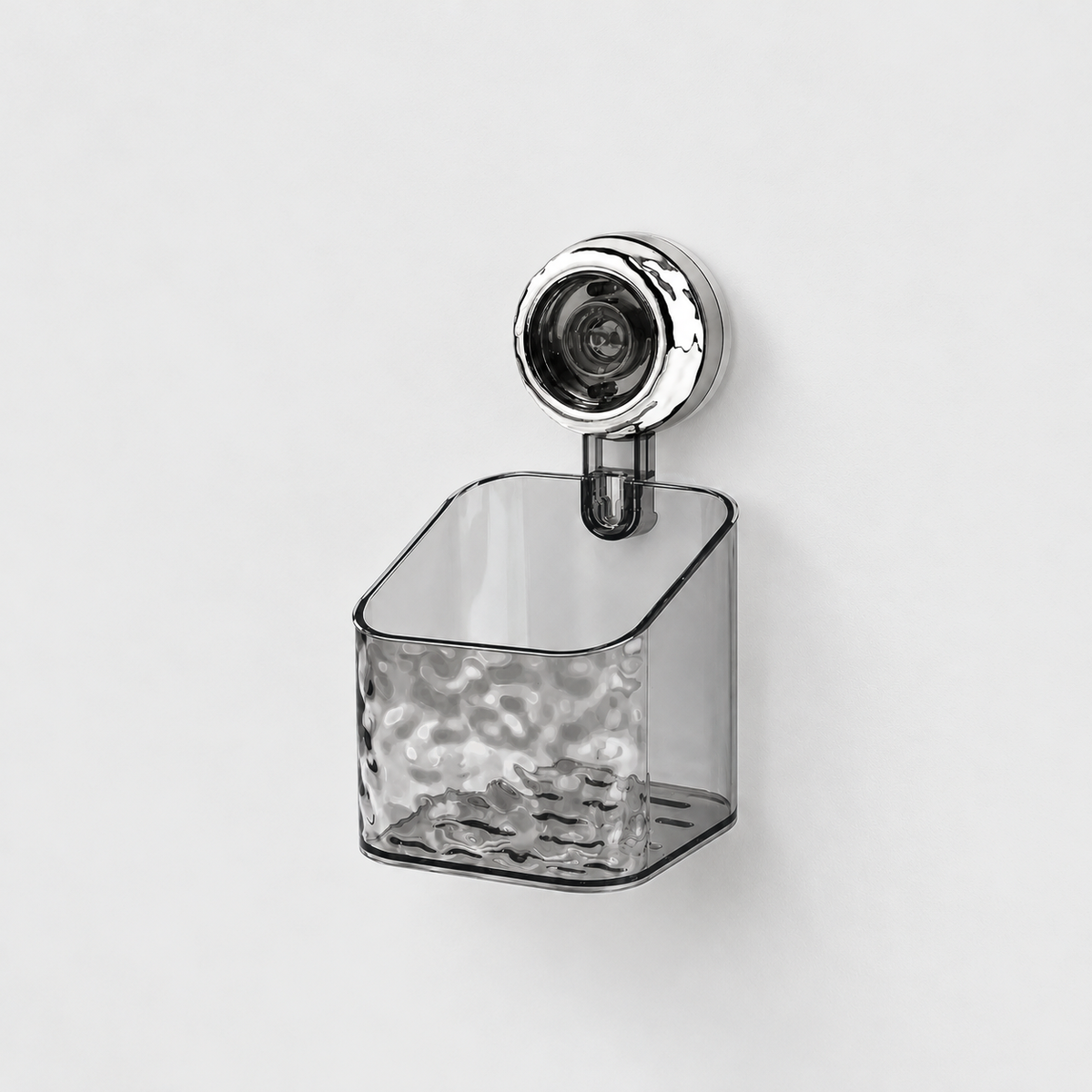 Gray see-through small holder with a rippled front and a sloping open top, on a single chrome suction cup