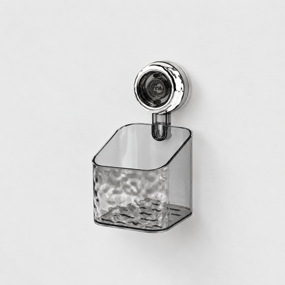 Gray see-through small holder with a rippled front and a sloping open top, on a single chrome suction cup