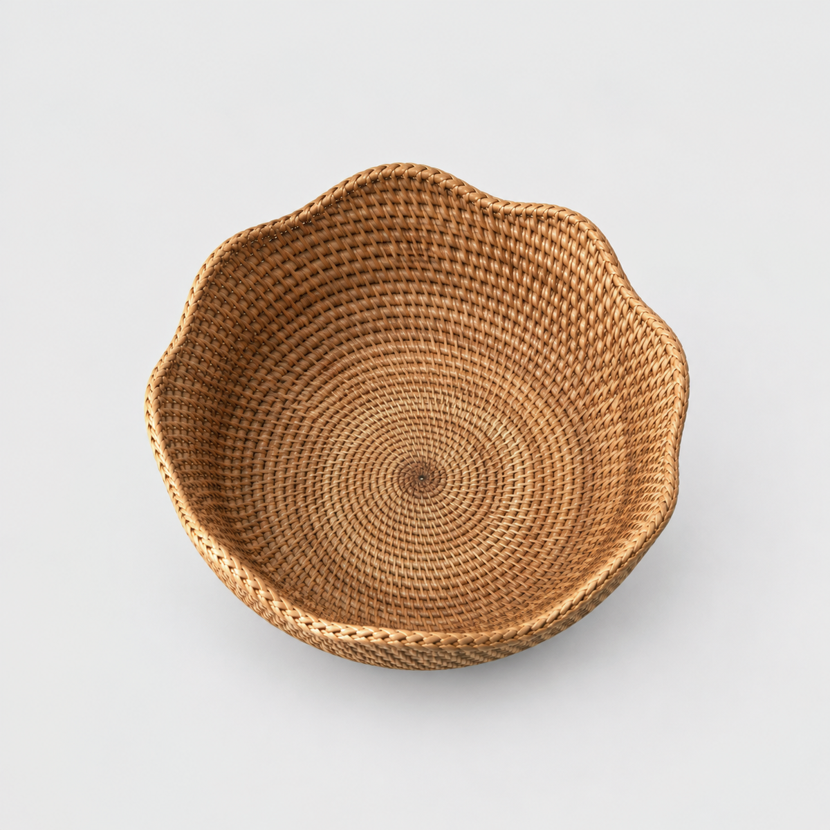 Looking down into the empty rattan bowl at its woven floor spiraling out from the center