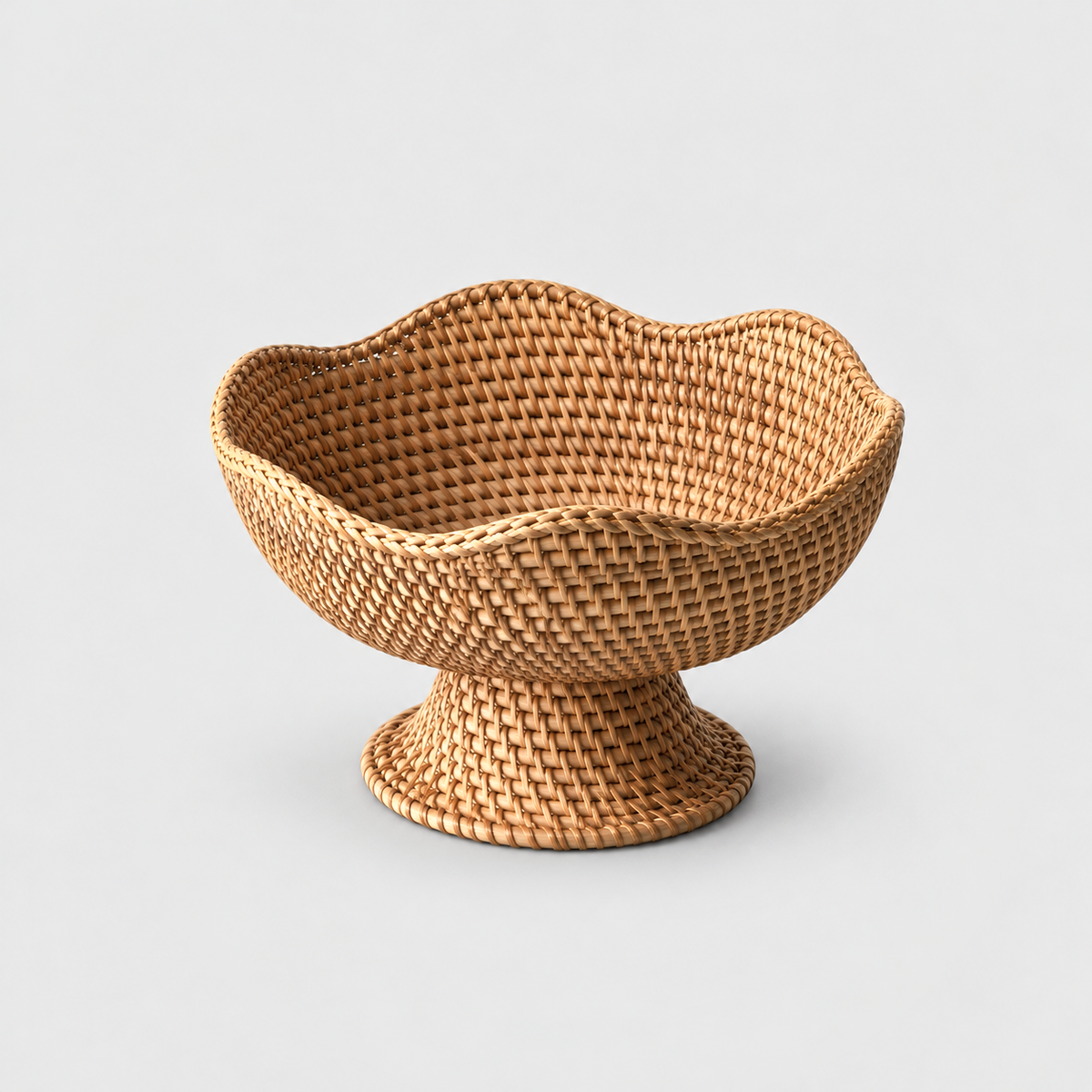 Woven rattan fruit bowl with a softly waved rim and a flared pedestal foot on a light gray background, the same design in the Small, Medium and Large size